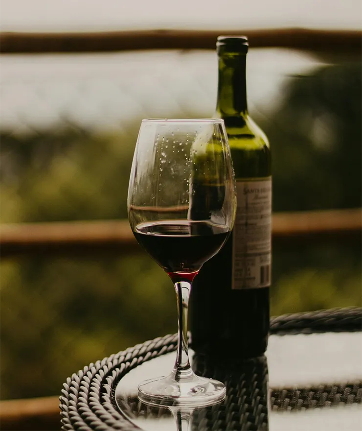 A glass and a wine bottle of Rioja in a table