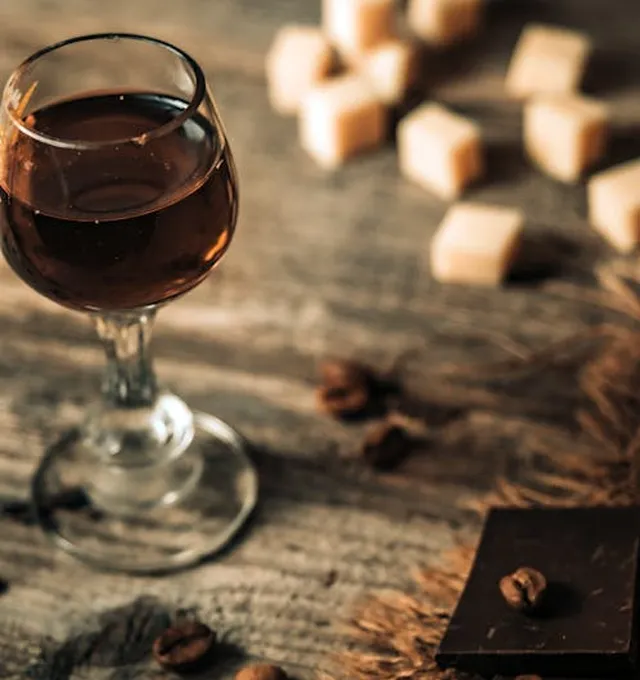 A glass of sweet fortified wine on a rustic table