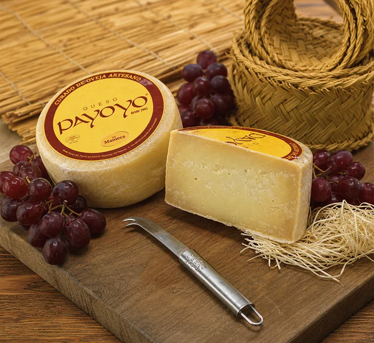 A spanish payoyo cheese with some grapes